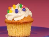 cupcake with buttercream frosting and colored chocolates