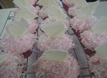 cupcakes with pink buttercream frosting and and coconut and white chocolate